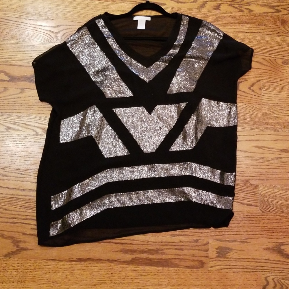 Black top with silver sequin pattern.